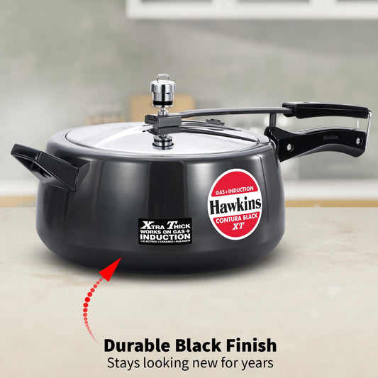 Black pressure cooker with Hawkins branding on a neutral background
