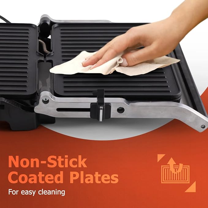 Person cleaning a grill with a cloth, emphasizing non-stick coated plates.