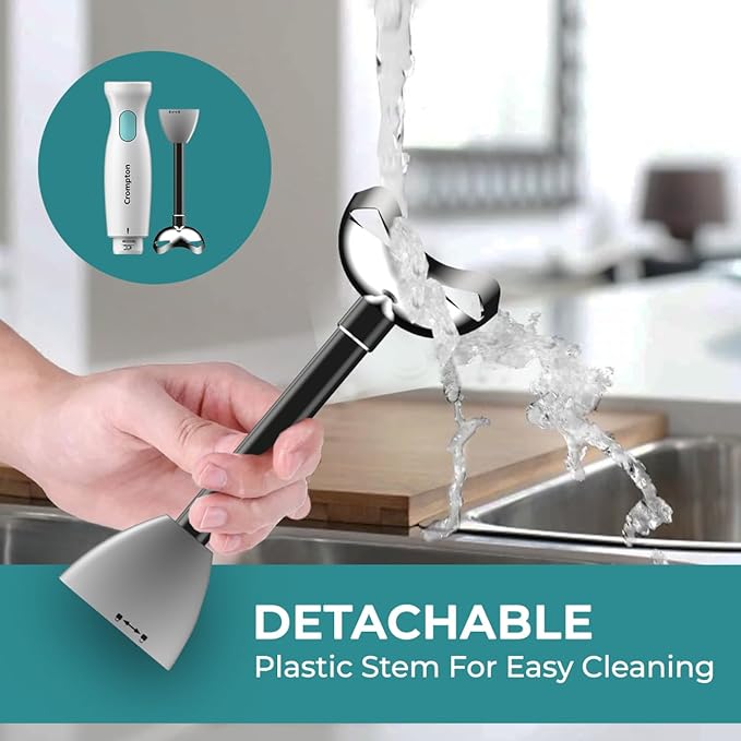 Hand holding a kitchen faucet with a detachable plastic stem, water flowing, and a blurred kitchen background.